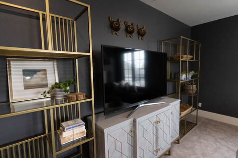 Down to Earth Projects | Kaysville Residence - gold shelves and tv with grey and gold console 