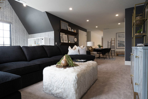 Down to Earth Projects | Kaysville Residence - basement family room  with dark sectional 