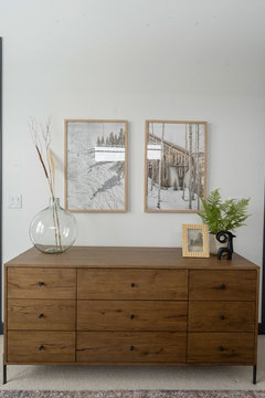 Down to Earth Projects | Eden Residence - wood dresser with photos on wall 