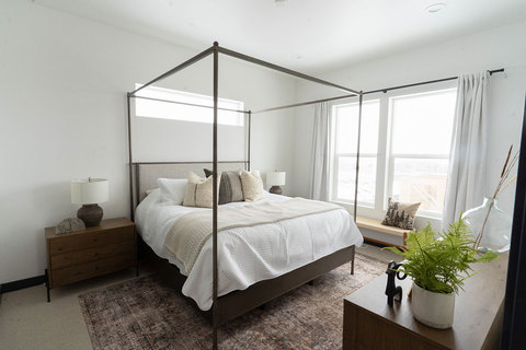Down to Earth Projects | Eden Residence - poster bed on rug in master bedroom 