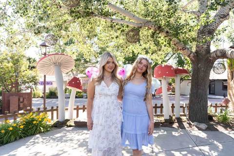 Woodland Fairy Festival - sisters standing by giant mushrooms 