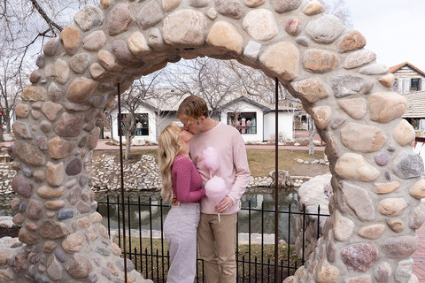 Lots to Love at Gardner Village - couple sitting in moon rock wall kissing 