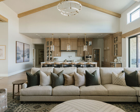 Down to Earth Projects | Utah Valley Parade at The Legacy at Meadow Ridge - sectional in family room adjacent to kitchen 