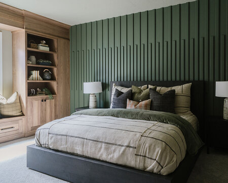 Down to Earth Projects | Utah Valley Parade at The Legacy at Meadow Ridge - bedroom with green millwork wall and gray bed with bedding from Layers Bedding 