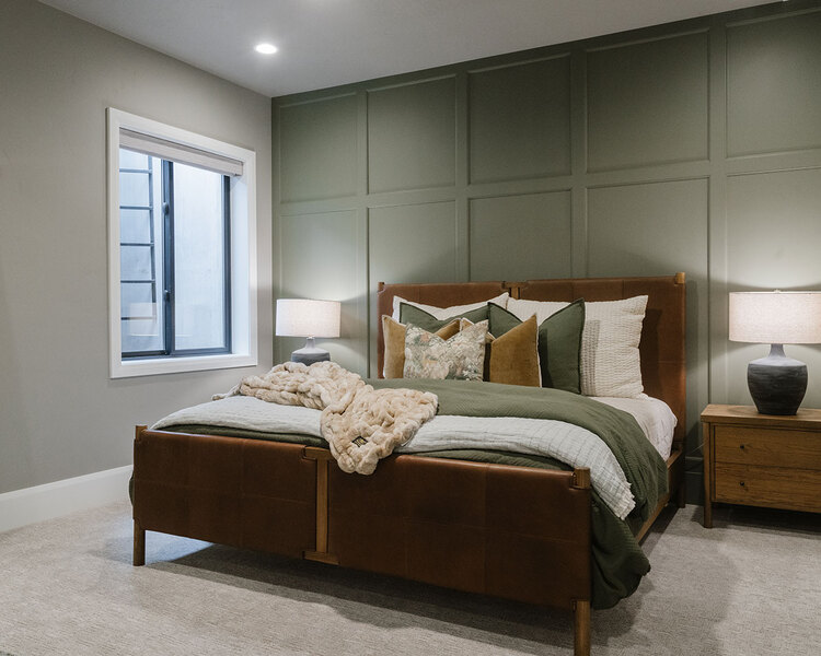 Down to Earth Projects | Utah Valley Parade at The Legacy at Meadow Ridge - Down to Earth Projects | Utah Valley Parade at The Legacy at Meadow Ridge - bedroom with sage green wall and leather and wood bed